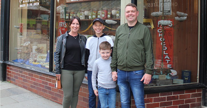 Gemma Peacock and her family standing outside the sweet shop at Beamish Museum